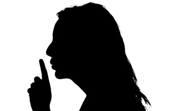 silhouette-of-a-woman-lifting-finger-to-her-lips